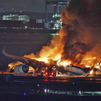 A Japan Airlines plane burns on the runway of Haneda airport on Tuesday, Jan. 2, 2024 in Tokyo.