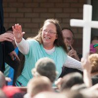 Rowan County Clerk of Courts Kim Davis waves to a crowd of her supporters at a rally in front of the Carter County Detention Center on Sept. 8, 2015 in Grayson, Ky.