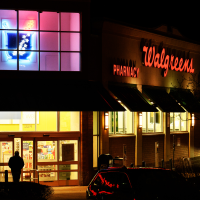 A Walgreens store at night with neon signs in Oakmont, Penn.