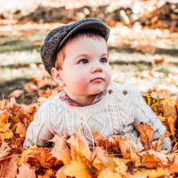 Retro Child Portrait in Leaves.