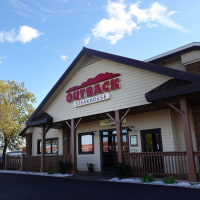 A sign marks the location of an Outback Steakhouse restaurant on November 02, 2021 in Skokie, Illinois. Shares of Bloomin’ Brands, the parent company of Outback Steakhouse, closed down 10% today after the company said it expects $170 million in additional costs next year due to inflation. 