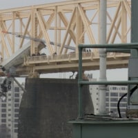 A semi-truck dangles off a bridge over the Ohio River.