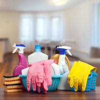 Cleaning products in a modern living room with kitchen.