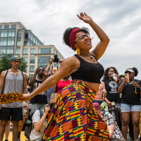 A woman dances to live music as she celebrates Juneteenth at
