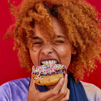 Portrait of woman eating a donut
