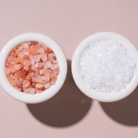 Himalayan Pink Salt and White Sea Salt in Bowls next to each other.