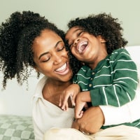 Mother and young son hugging.