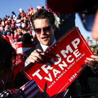 U.S. Rep. Matt Gaetz (R-FL),  prepares to sign a Trump-Vance sign at a campaign rally in Coachella, Calif. on Oct. 12, 2024. 