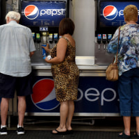 Customers fill cups with PepsiCo. Inc. brand beverages at the food court of a Costco Wholesale Corp. store in San Antonio, Texas, U.S., on Wednesday, May 30, 2018. Costco Wholesale Corp. is releasing earnings figures on May 31. 