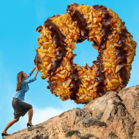 A woman carrying a Simosa cookie uphill