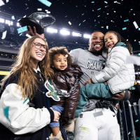 Saquon Barkley #26 of the Philadelphia Eagles celebrates with his family.