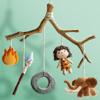 Wooden baby mobile with a fire, spear, stone wheel, cavewoman, and mammoth plush toys attached via string