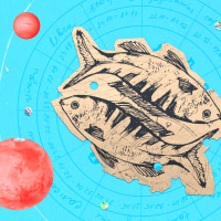 Paper cutout of the pisces zodiac on a blue background