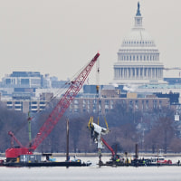 A crane removes airplane wreckage from the Potomac River on Feb. 3, 2025.