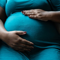 Pregnant woman touching her belly