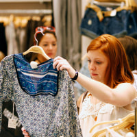 A customer looks at a top inside a Forever 21 store.