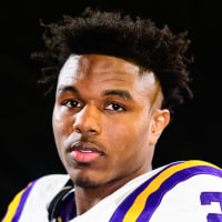 Kyren Lacy in his football uniform poses against a black background