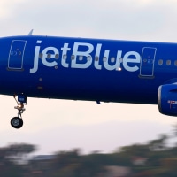 A JetBlue Airways Airbus A321 airplane approaches San Diego International Airport