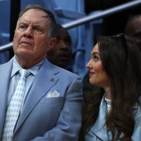 North Carolina Tar Heels football head coach Bill Belichick and his girlfriend Jordon Hudson look on during the first half of the game between the North Carolina Tar Heels and the Duke Blue Devils at Dean E. Smith Center on March 08, 2025 in Chapel Hill, North Carolina. 