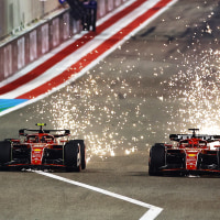 Sparks fly from the cars of Carlos Sainz of Spain driving (55) the Ferrari SF-24 and Charles Leclerc of Monaco driving the (16) Ferrari SF-24 as they compete for track position.