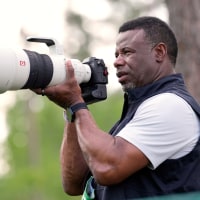 Former MLB legend Ken Griffey Jr. takes photos on the 12th hole during the second round at the Masters golf tournament April 11.
