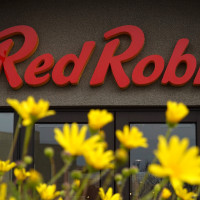 A sign is posted on the exterior of a Red Robin restaurant on December 18, 2024 in San Bruno, California. 