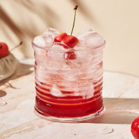 refreshing mocktail with ice and cherries