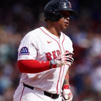 May 8, 2025; Boston, Massachusetts, USA; Boston Red Sox designated hitter Rafael Devers (11) hits a home run against the Texas Rangers in the seventh inning at Fenway Park. Mandatory Credit: David Butler II-Imagn Images