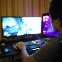 A boy plays a game on a computer.