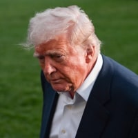 President Donald Trump leaves after taking questions from reporters