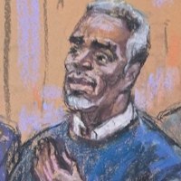 Sean "Diddy" Combs puts his hand on his heart as he enters the courtroom for jury selection at the start of his sex trafficking trial in New York on May 6, 2025.