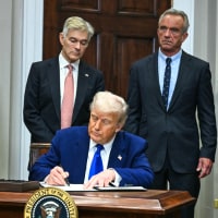 Image: President Donald Trump signs an executive order on prescription drug prices