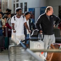 People wait in line at the airport