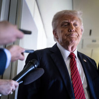 President Donald Trump listens to questions 