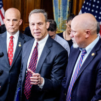 Clay Higgins, Andy Harris, Chip Roy, Scott Perry, and Keith Self in the center of a crowd of interviewers