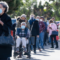 People wait in line to get the vaccine.