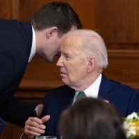 Jacob Spreyer, personal aide, speaks to the president during the annual Friends Of Ireland Speaker Luncheon at the Capitol on March 15, 2023.