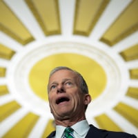 John Thune speaks to reporters
