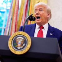 President Donald Trump speaks into a microphone