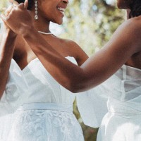 black lesbian couple dancing during wedding.