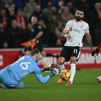 Nottingham Forest's Belgian goalkeeper #26 Matz Sels saves the ball from the feet of Liverpool's Egyptian striker #11 Mohamed Salah during the English Premier League football match between Nottingham Forest and Liverpool at The City Ground in Nottingham, central England, on January 14, 2025. (Photo by Paul ELLIS / AFP) / RESTRICTED TO EDITORIAL USE. No use with unauthorized audio, video, data, fixture lists, club/league logos or 'live' services. Online in-match use limited to 120 images. An additional 40 images may be used in extra time. No video emulation. Social media in-match use limited to 120 images. An additional 40 images may be used in extra time. No use in betting publications, games or single club/league/player publications. /  (Photo by PAUL ELLIS/AFP via Getty Images)