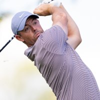 May 8, 2025; Philadelphia, Pennsylvania, USA; Rory McIlroy plays his shot from the first tee during the first round of the Truist Championship golf tournament. Mandatory Credit: Bill Streicher-Imagn Images
