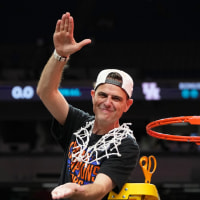 Apr 7, 2025; San Antonio, TX, USA; Florida Gators head coach Todd Golden reacts after cutting down a piece of the net after winning the national championship game of the Final Four of the 2025 NCAA Tournament at the Alamodome. Mandatory Credit: Bob Donnan-Imagn Images