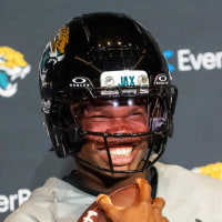 The Jacksonville Jaguars’ first-round pick, Colorado Buffaloes wide receiver and defensive back Travis Hunter sits in his chair with his helmet on and acting as if he was running after answering questions during a press conference Friday, March 25, 2025 at Miller Electric Center in Jacksonville, Fla. [Doug Engle/Florida Times-Union]