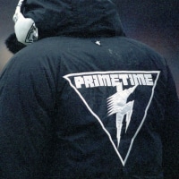 WASHINGTON, DC - NOVEMBER  10:  Cornerback Deion Sanders of the Atlanta Falcons looks on from the sideline while wearing a jacket bearing his nickname - PrimeTime - during a game against the Washington Redskins at RFK Stadium on November 10, 1991 in Washington, DC.  Washington defeated the Falcons 56-17.  (Photo by George Gojkovich/Getty Images)