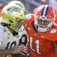 Notre Dame quarterback Sam Hartman (10) runs by Clemson defensive lineman Peter Woods (11) for a touchdown during the third quarter at Memorial Stadium in Clemson, S.C. Saturday, November 4, 2023.