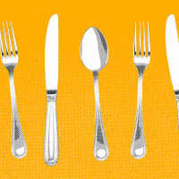 Forks, knives, and spoons lined up against a yellow background.