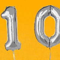 Balloons that spell the number 100, against a yellow background.