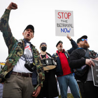 Protesters shout during a "Veterans March" at the National Mall on March 14, 2025.