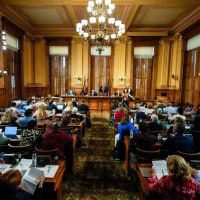 Georgia's State Election Board members discuss proposals to a full room for election rule changes at the state capitol on Sept. 20, 2024, in Atlanta.